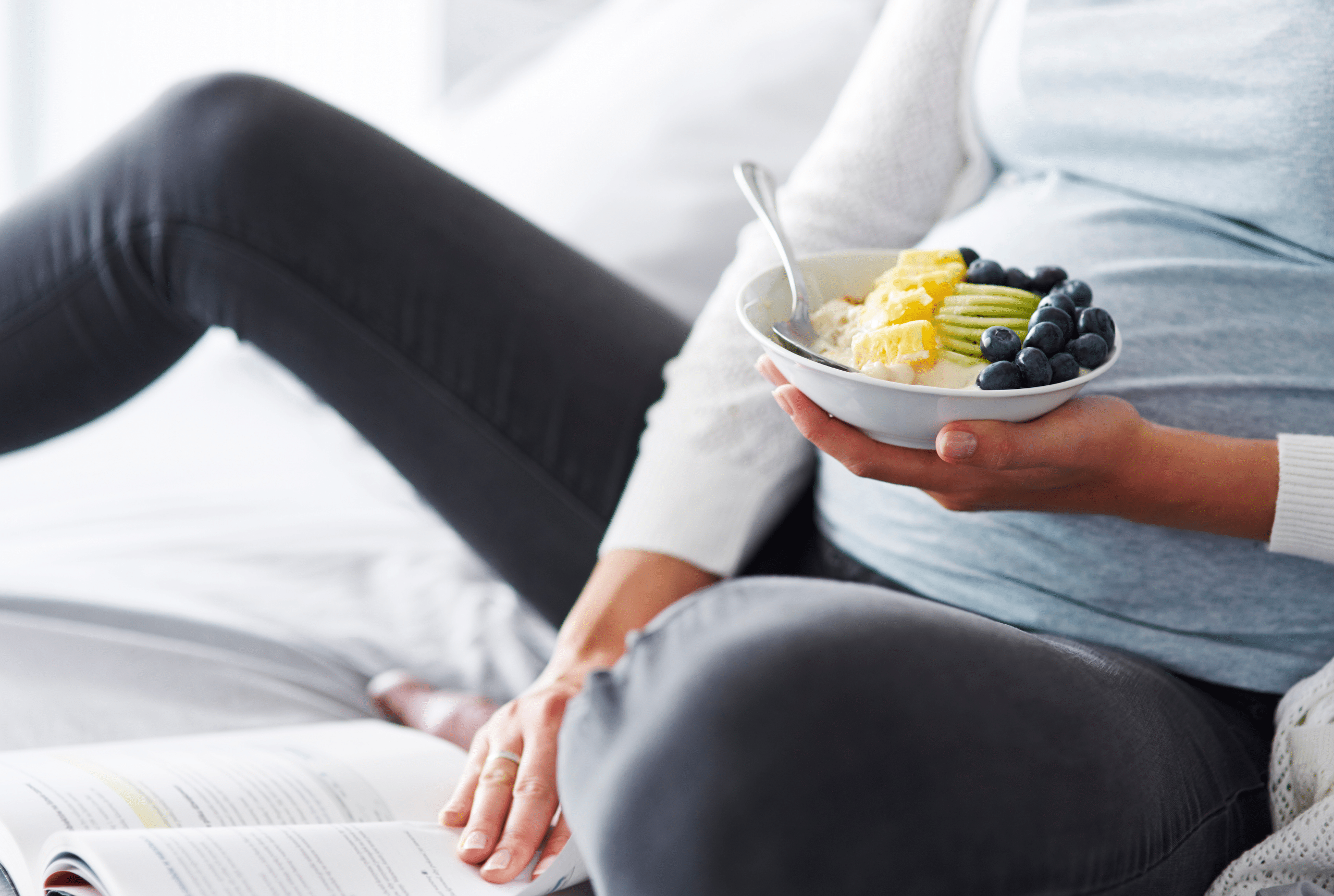 Pregnant woman eating fruit