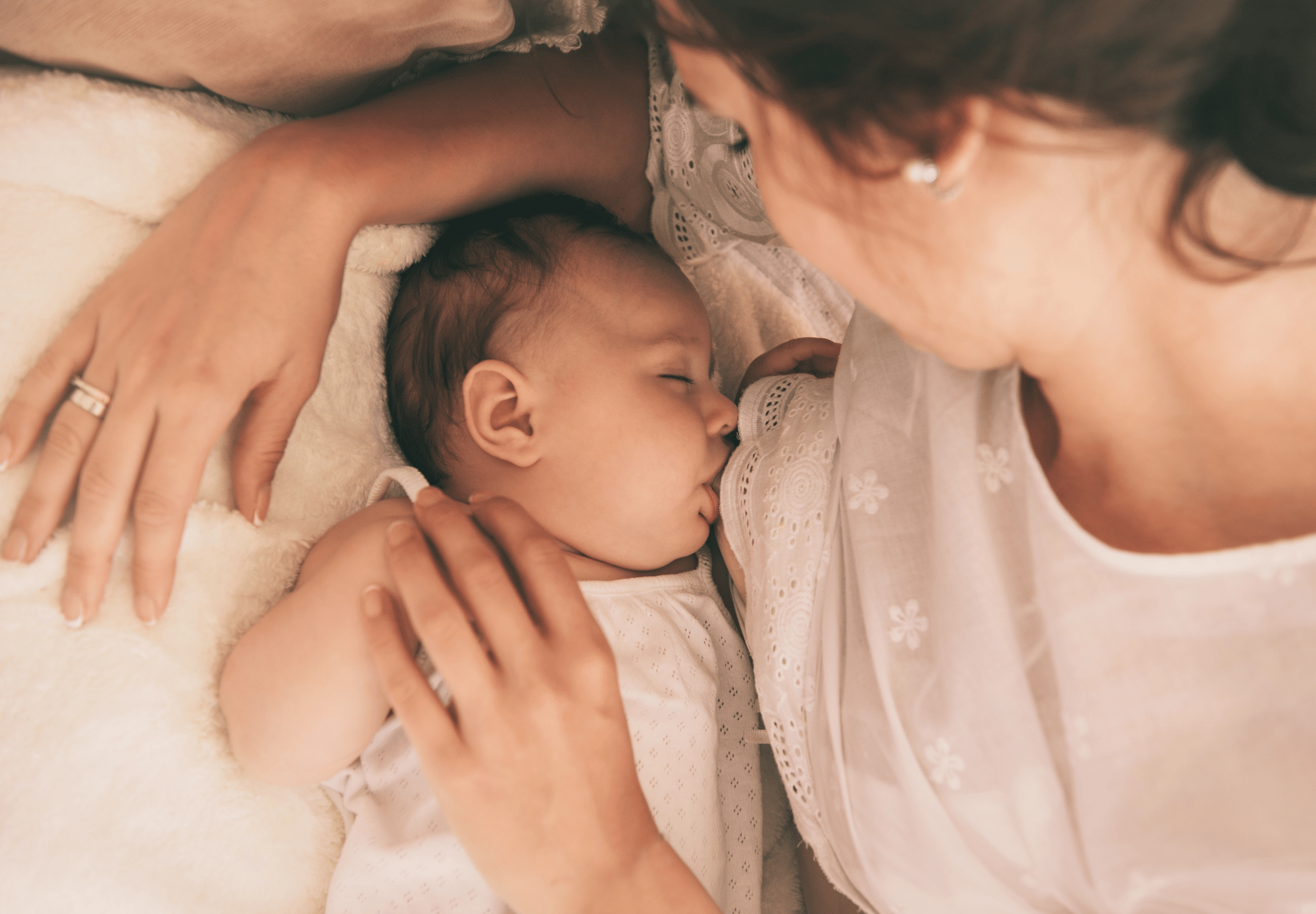 baby breastfeeding with mom