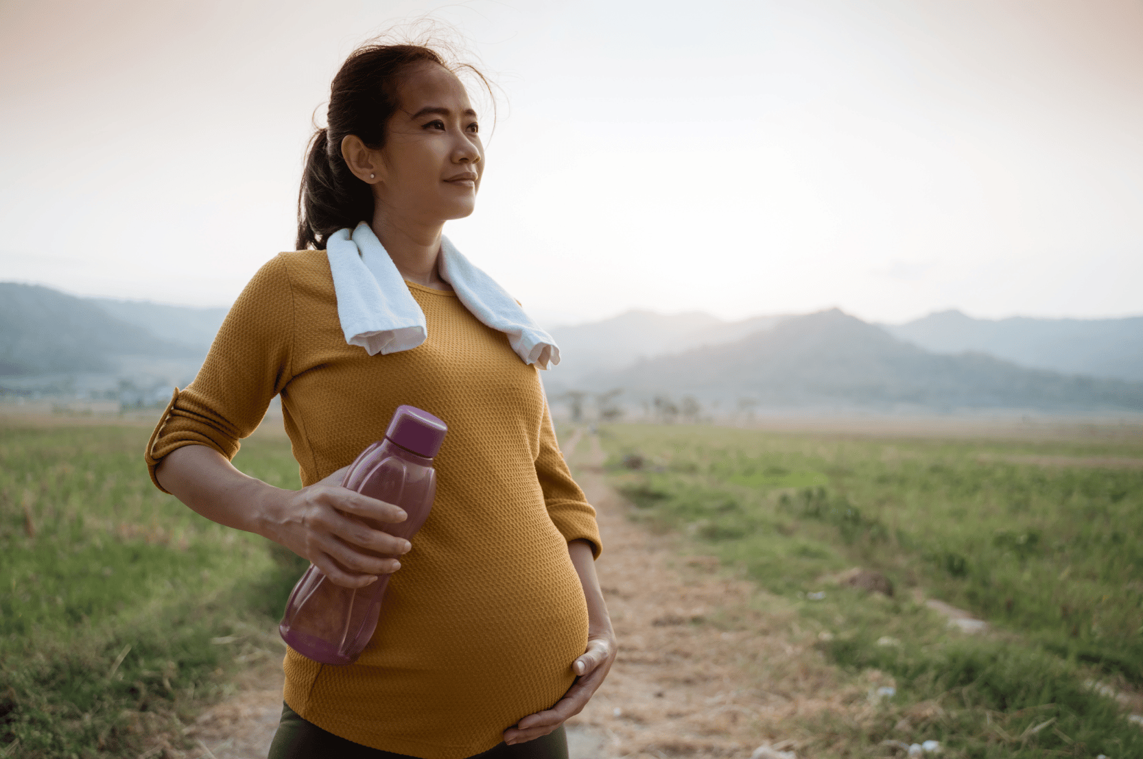 pregnant woman on a hike in the hills